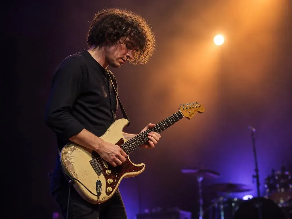 Rock guitarist portrait under stage lights